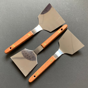 Okonomiyaki utensils with a wooden handle