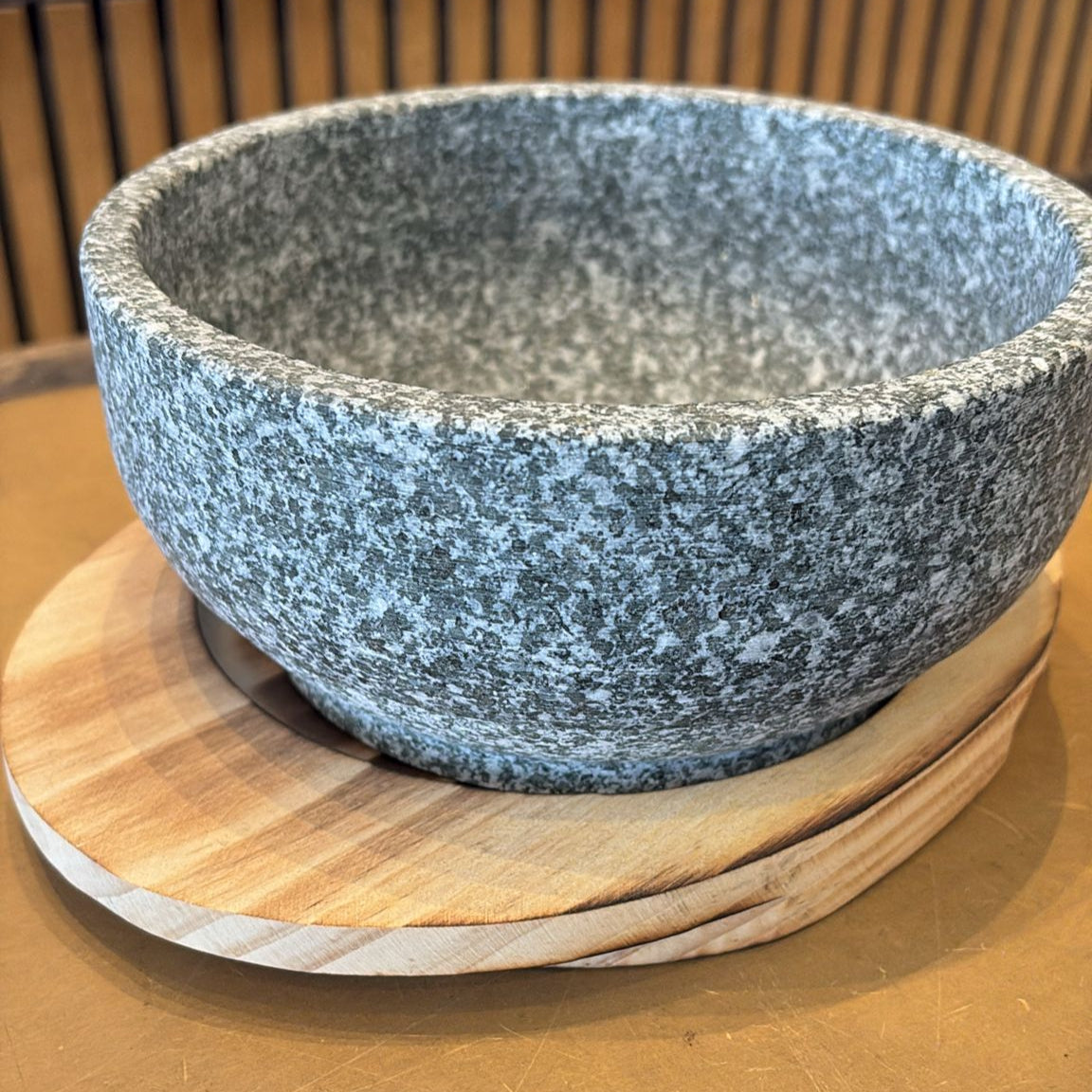 Dolsot bowl with a wooden stand